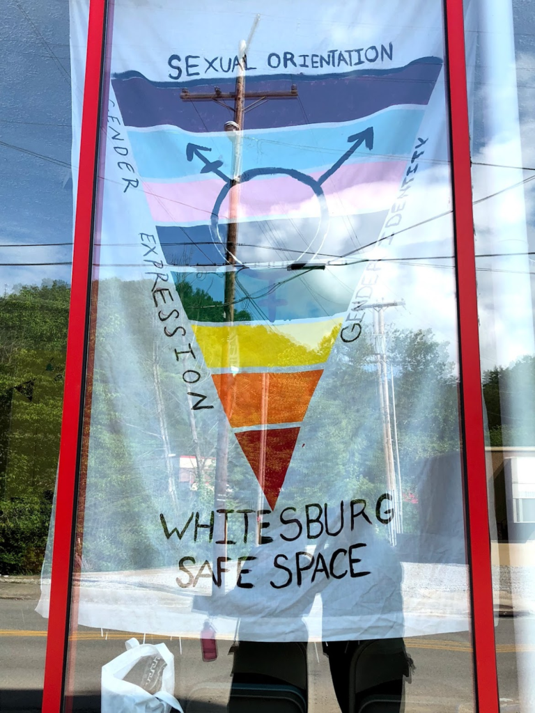 A Whitesburg Safe Space banner in Pride and transgender flag colors at the Boone Motor Building in Whitesburg