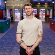 Chase Maus, a Kentucky pastry chef and Season 12 contestant on Food Network’s Holiday Baking Championship, smiles on the show’s holiday themed kitchen set.