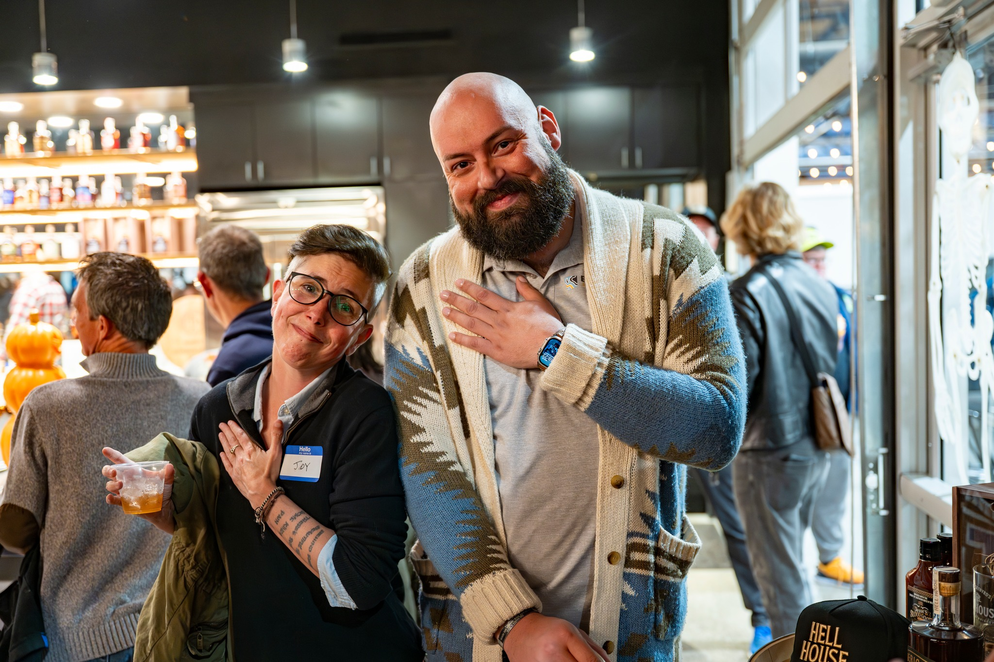 Attendees smile and pose at Lexington’s ‘Last WednesGays’ queer meetup inside a local bar, a monthly LGBTQIA+ networking event creating a safe, inclusive community space.