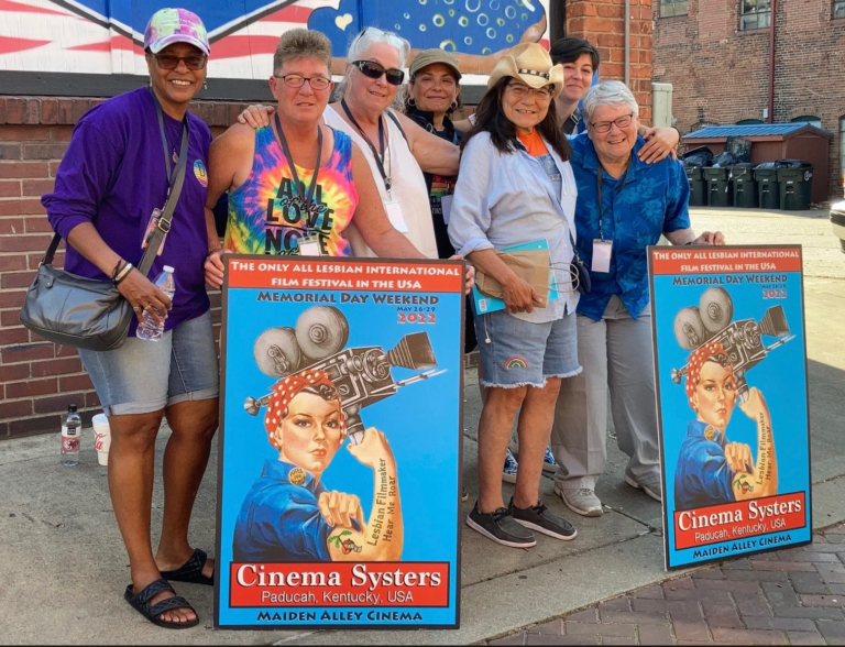 Attendees pose with posters at the Cinema Systers lesbian film festival in Paducah
