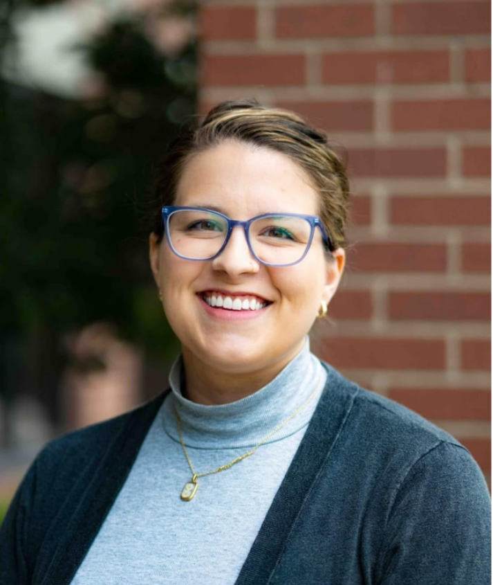 Sandra Carpenter, Executive Director of Louisville Youth Group, smiling in front of a brick wall. The Louisville Youth Group logo appears to the right.