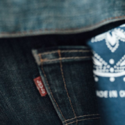 A blue handkerchief hanging from the back left pocket of blue jeans