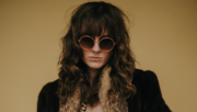 TBALLER, Northern Kentucky artist, poses in leopard print and a vintage fur coat during a photoshoot.
