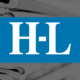 The Lexington Herald-Leader logo over a black-and-white photograph of stacked newspapers.