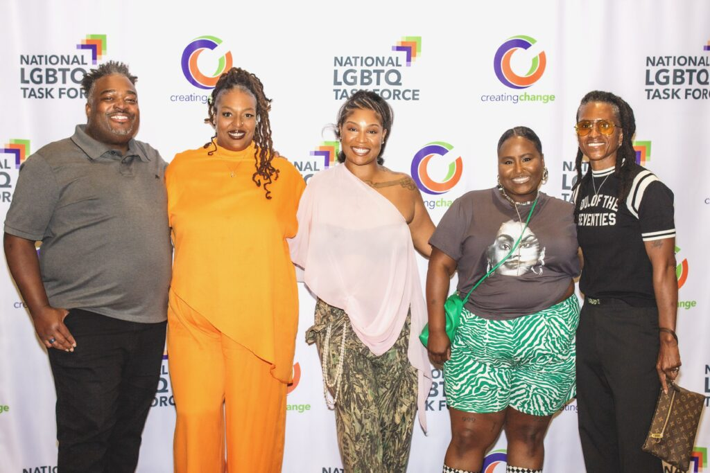 Five people pose in front of a National LGBTQ Task Force and Creating Change backdrop at the Creating Change Kickoff Mixer.