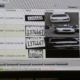 A computer screen showing license plate reader software results. The same plate number is logged four times on different dates by different cameras, each entry with a close-up of the plate and a photo of the white car it belongs to.